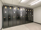 Thumbnail 24 of 26 - A row of black lockers with yellow and blue labels for Fold Cleaners.