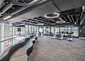 Thumbnail 3 of 35 - A modern office space with black leather seating and large windows.