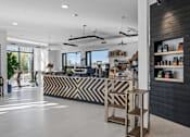 Thumbnail 2 of 35 - A modern store interior with a black and white striped counter.