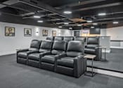 Thumbnail 8 of 35 - A row of black leather reclining chairs are lined up in a room.