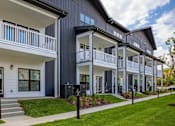 Thumbnail 22 of 25 - A row of modern houses with balconies and white railings.