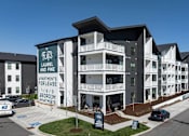 Thumbnail 23 of 25 - A building with a sign that says "Flats Laurel and Pine Apartments for lease 1/1/3 bedroom apartments".