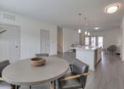 Thumbnail 5 of 25 - A dining room with a round table and chairs.