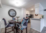 Thumbnail 5 of 27 - a dining room with a table and chairs and a kitchen