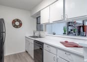 Thumbnail 2 of 27 - a kitchen with white cabinets and a sink and a refrigerator