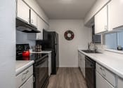 Thumbnail 3 of 27 - a kitchen with white cabinets and black appliances