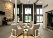 Thumbnail 24 of 27 - a living room with couches and chairs and a stone fireplace