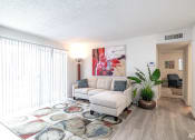 Thumbnail 4 of 27 - a living room with a couch and a rug