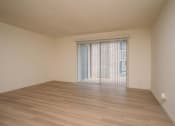 Thumbnail 13 of 27 - the living room of an empty house with wood floors and a window