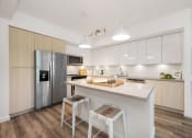 Thumbnail 1 of 66 - a kitchen with a large island and a stainless steel refrigerator