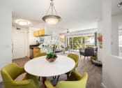 Thumbnail 37 of 41 - a dining room with a white table and green chairs