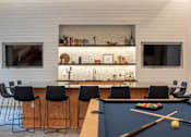 Thumbnail 9 of 16 - A pool table with a cue and balls in the middle of it.