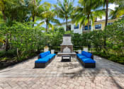 Thumbnail 11 of 44 - a courtyard with blue couches and a fountain
