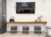 Thumbnail 3 of 29 - a room with a television and three stools