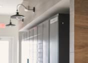 Thumbnail 16 of 29 - a view down a hallway with a row of lockers on the left and three lights on
