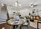 Thumbnail 10 of 16 - A modern dining room with a round table set for two.