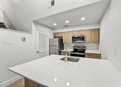 Thumbnail 7 of 24 - a kitchen with a white counter top and a sink