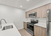 Thumbnail 1 of 24 - a kitchen with white countertops and wooden cabinets