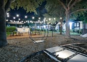 Thumbnail 21 of 29 - a night view of a park with trees and lights