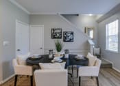Thumbnail 2 of 29 - a dining room with a table and chairs