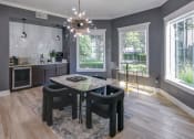 Thumbnail 13 of 29 - a dining area with a table and chairs and a chandelier