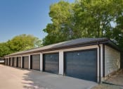 Thumbnail 18 of 29 - a row of garages in front of trees
