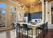 Thumbnail 7 of 33 - a kitchen with a large center island with a marble countertop