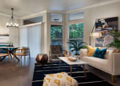 Thumbnail 14 of 33 - a living room and dining room with a table and chairs