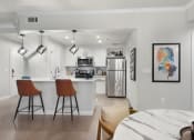 Thumbnail 16 of 33 - a kitchen and dining area in a 555 waverly unit