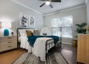 Thumbnail 18 of 33 - a bedroom with a bed and a ceiling fan