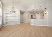 Thumbnail 20 of 33 - a spacious living room with a kitchen in the background