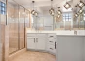 Thumbnail 21 of 33 - a bathroom with a large shower and two sinks