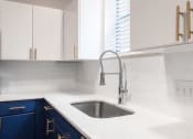 Thumbnail 13 of 49 - white counter tops with blue cabinets in the kitchen