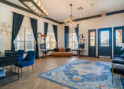 Thumbnail 19 of 36 - a living room with blue curtains and a blue rug and a piano