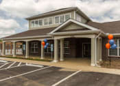 Thumbnail 14 of 15 - the front of a building with balloons outside of it