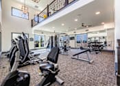Thumbnail 22 of 32 - A spacious home gym with a variety of exercise equipment.