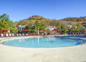 Thumbnail 4 of 25 - a resort pool with chairs and umbrellas on a sunny day