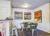Thumbnail 16 of 25 - a dining room with a table and chairs and a clock on the wall