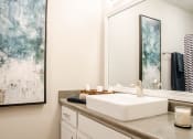 Thumbnail 18 of 25 - a bathroom with a sink and a mirror on the wall