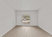 Thumbnail 3 of 24 - an empty living room with a door to a driveway