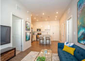 Thumbnail 14 of 45 - a living room and kitchen with a couch and a table
