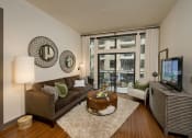 Thumbnail 7 of 23 - a living room filled with furniture and a large window