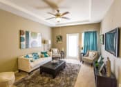 Thumbnail 1 of 15 - a living room with furniture and a ceiling fan