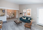 Thumbnail 3 of 22 - A living room with a blue couch and a coffee table.