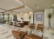 Thumbnail 13 of 23 - a living room with a table and chairs and a lobby