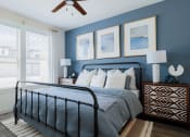 Thumbnail 10 of 43 - a bedroom with blue walls and a ceiling fan