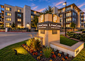 Thumbnail 30 of 30 - A LynnCora sign is in front of a building with a garden in front of it.