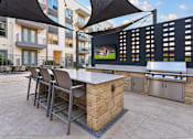 Thumbnail 11 of 30 - A patio with a bar and chairs under a black umbrella.