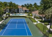 Thumbnail 29 of 52 - an aerial view of a tennis court with a pool and villas in the background