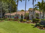 Thumbnail 42 of 52 - a house with palm trees and a sign in the yard